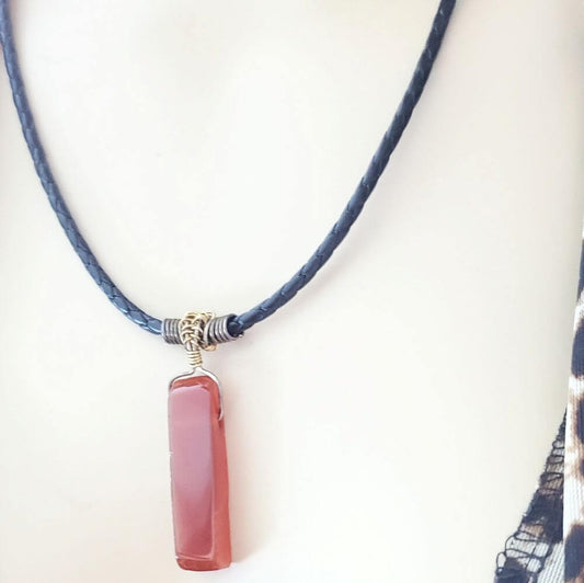 Necklace with a pink pendant on a white background
