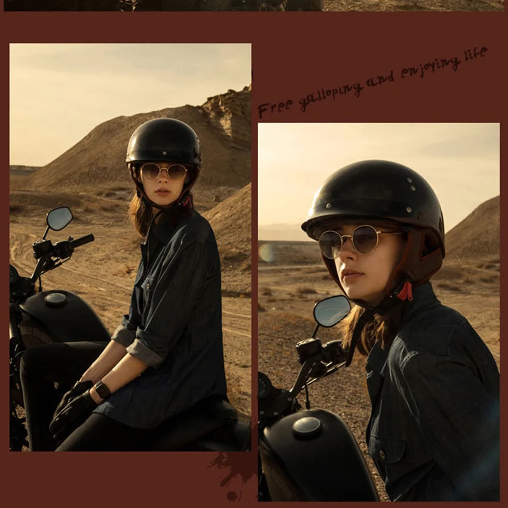 Woman with a helmet and sunglasses sitting on a motorcycle in a desert landscape.