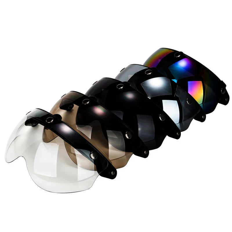 Set of visors with reflective lenses on a white background