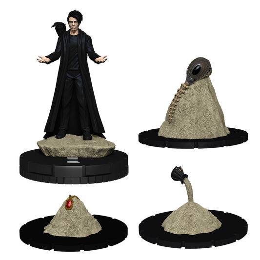 Collection of fantasy figurines including a character in a black robe and three creature heads on stands.