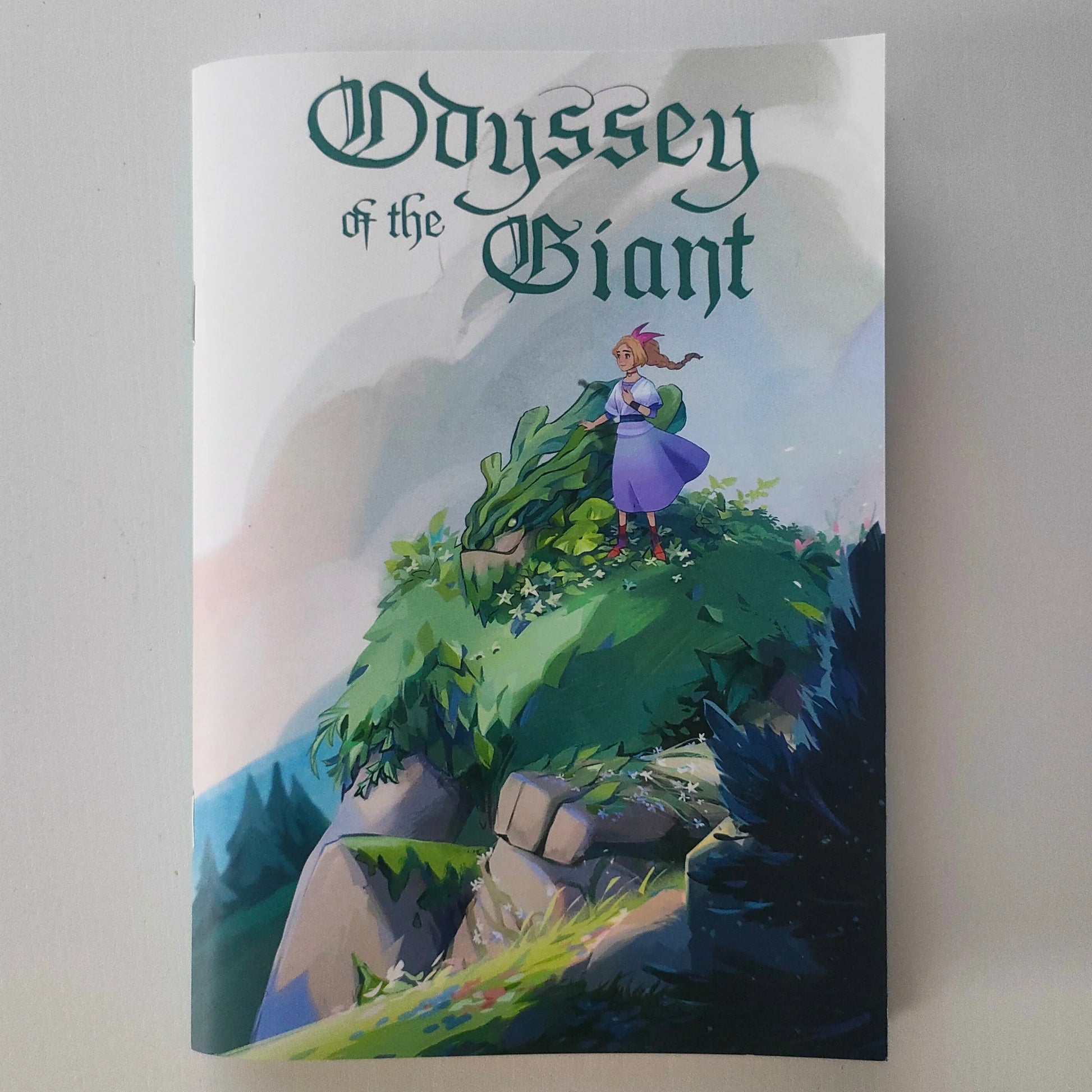 Book cover of 'Odyssey of the Giant' with a character on a cliff.