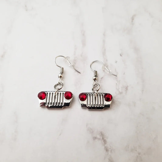Pair of earrings with grill design on a marble surface