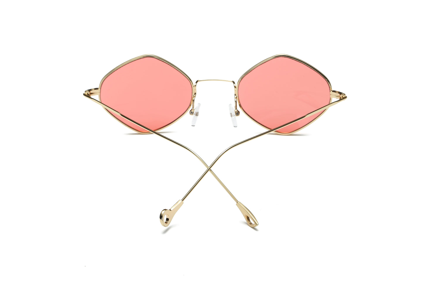 Sunglasses with pink lenses and gold frames on a white background