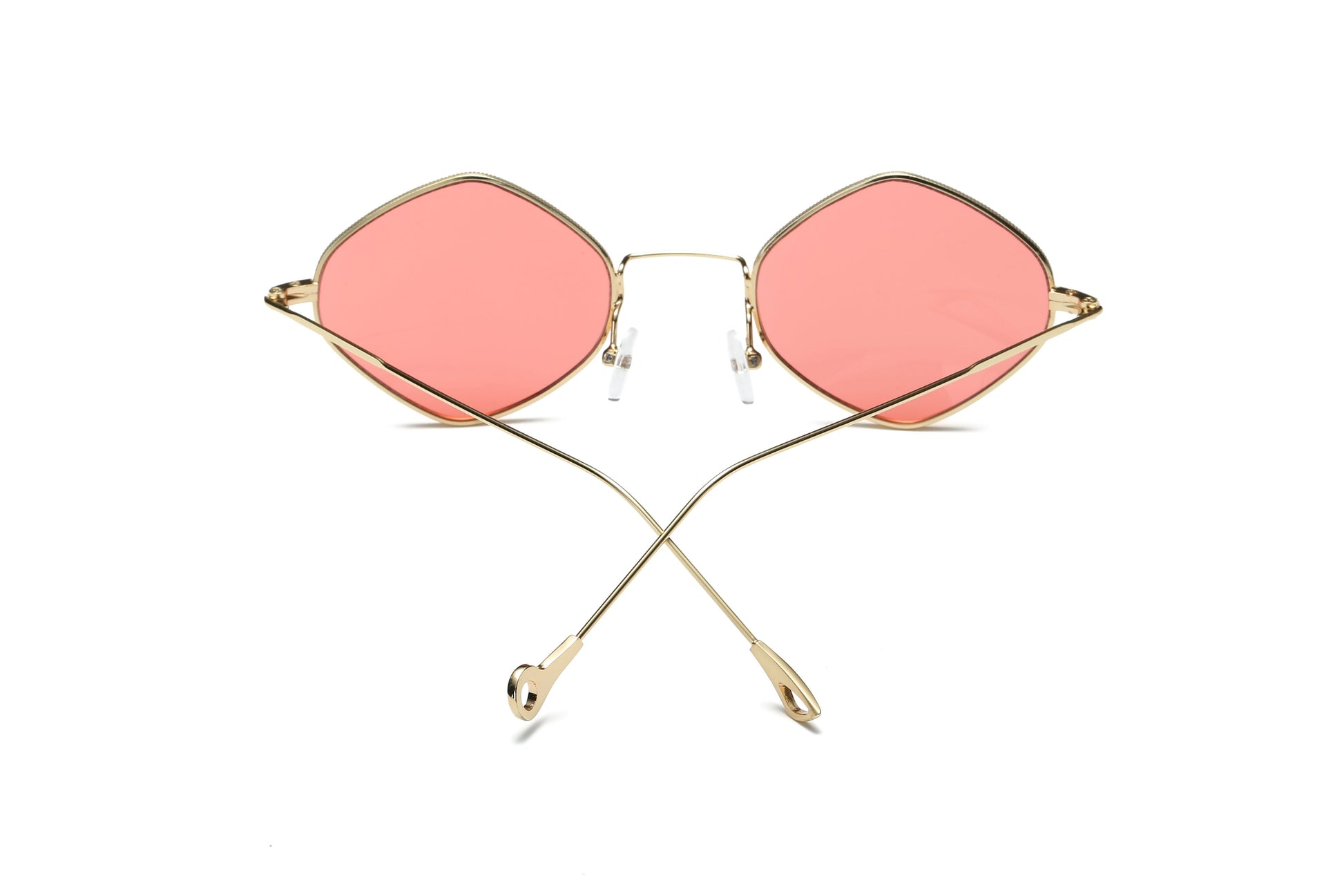 Sunglasses with pink lenses and gold frames on a white background