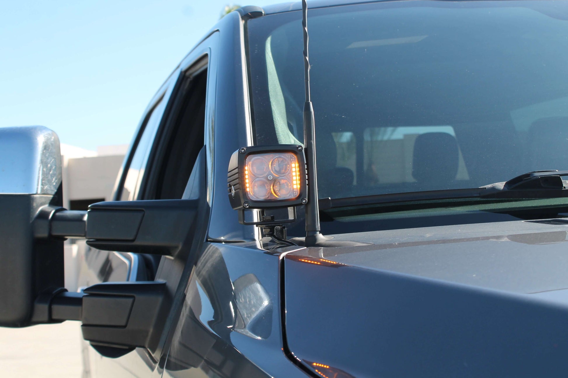 Side view of a vehicle with a side mirror and Hood Light