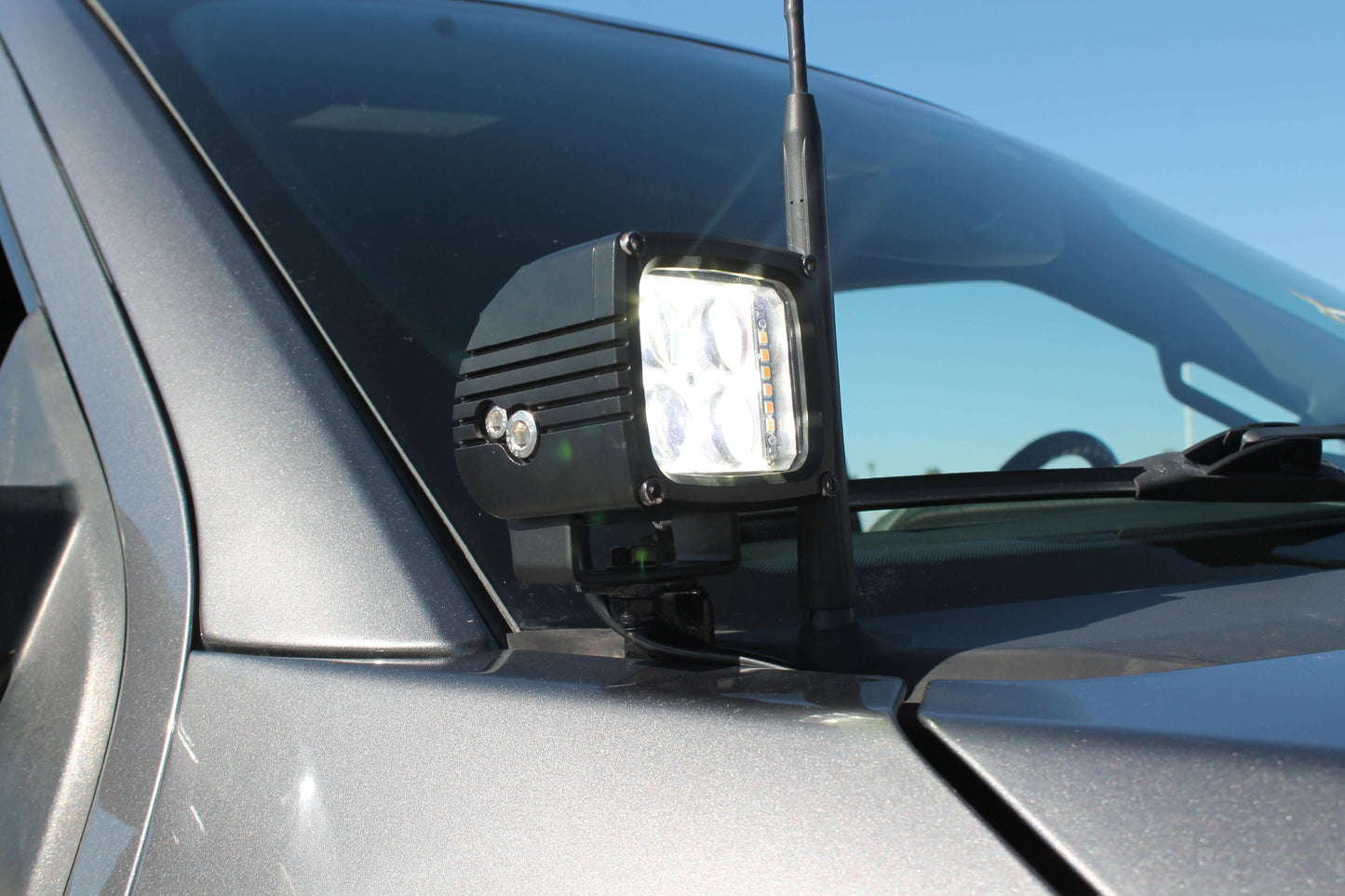 Car with a mounted LED light on the hood