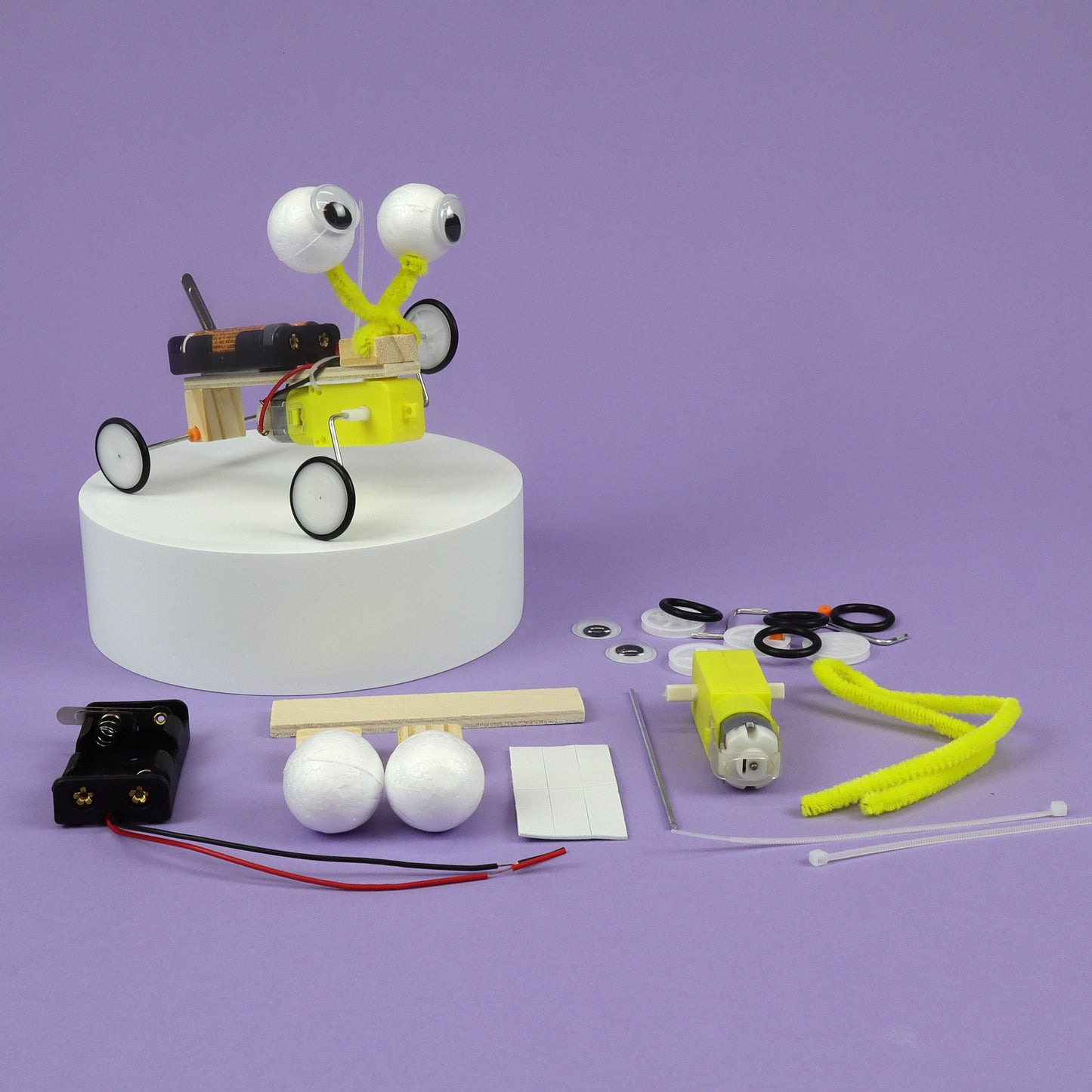 Science experiment kit with components on a purple background