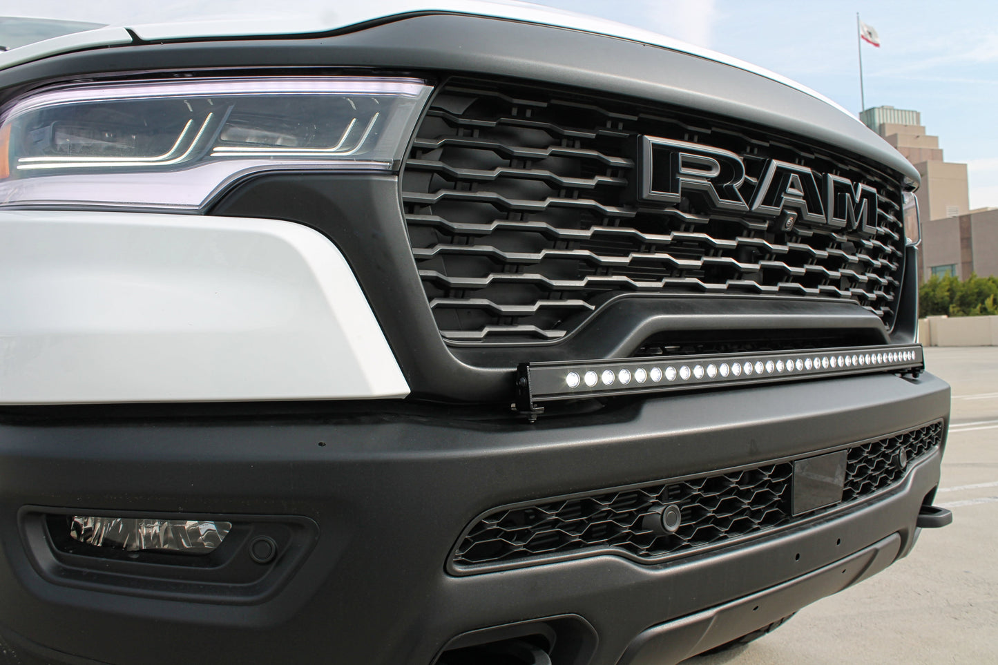 Close-up of a Ram truck grille with LED light bar
