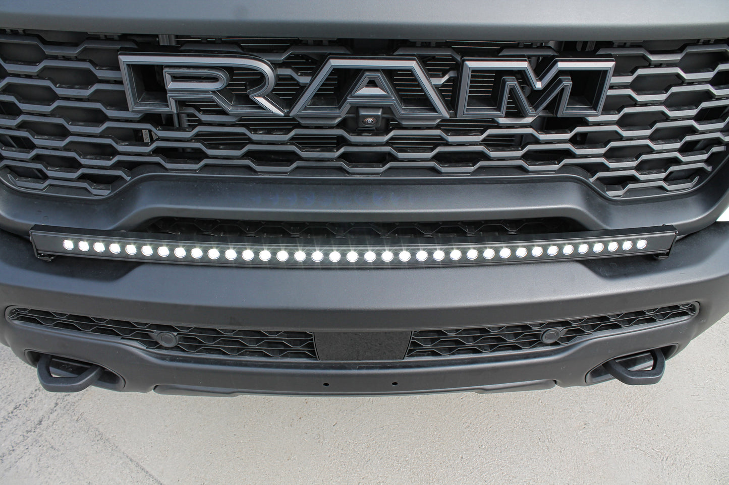 Close-up of a Ram truck grille with LED light bar