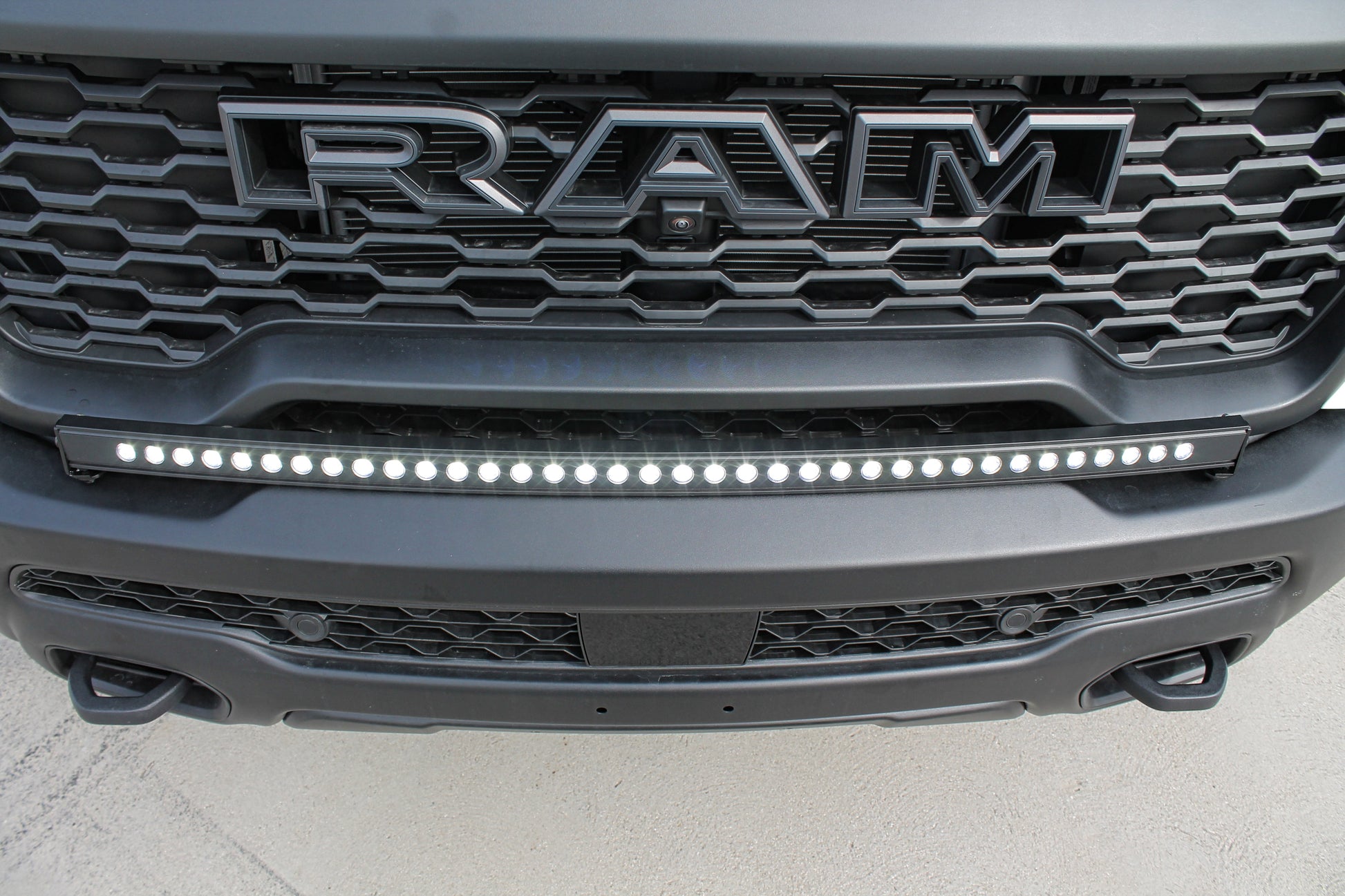 Close-up of a Ram truck grille with LED light bar