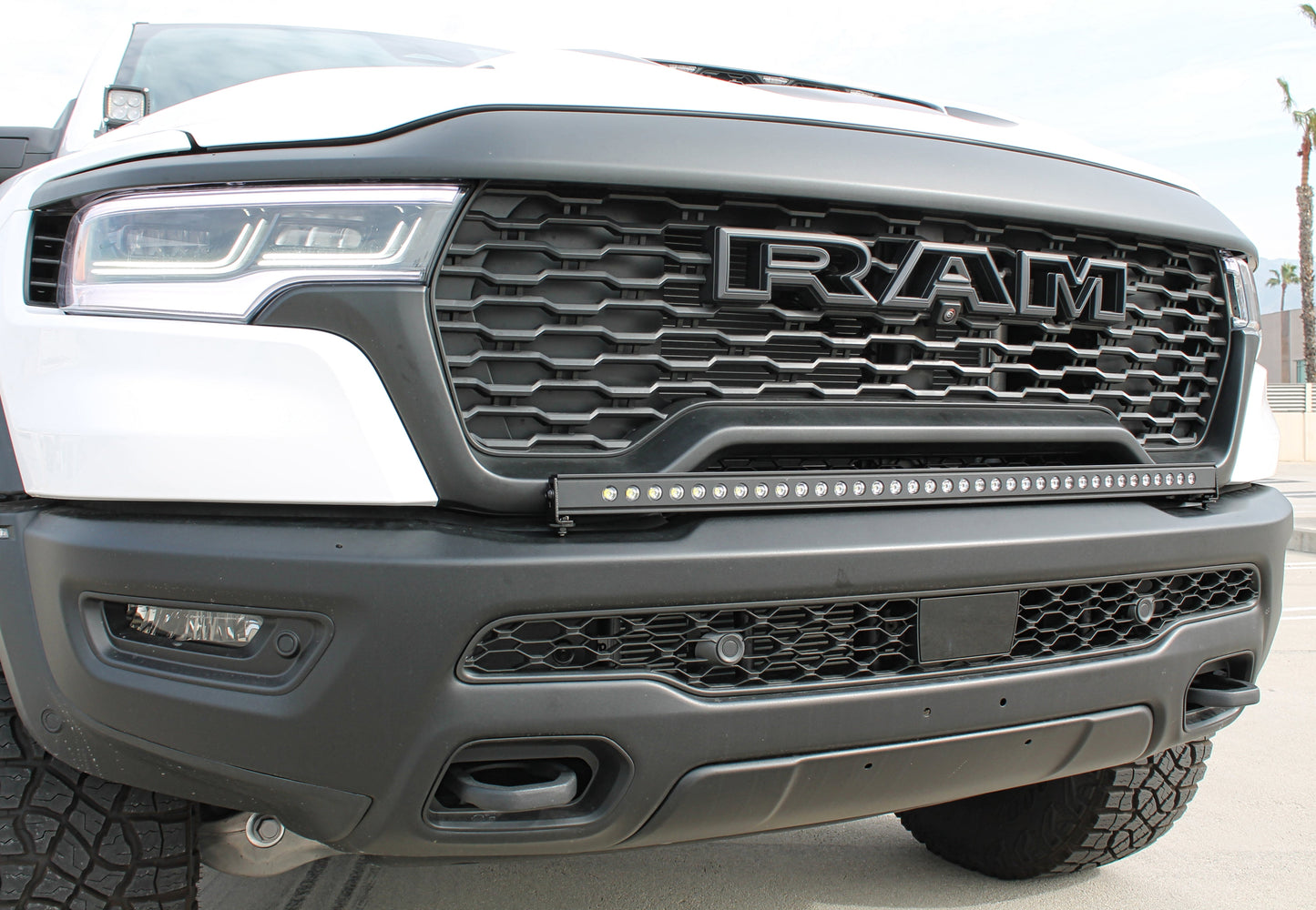 Close-up of a Ram truck grille with prominent LED Light Bar.