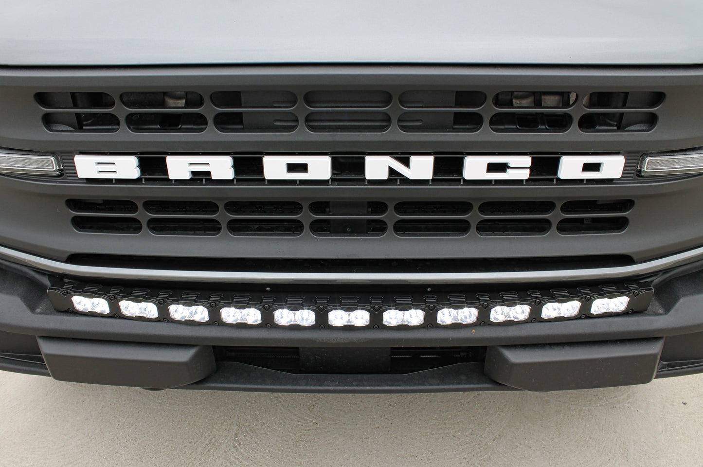 Ford Bronco grille with 'Bronco' branding and LED light bar.