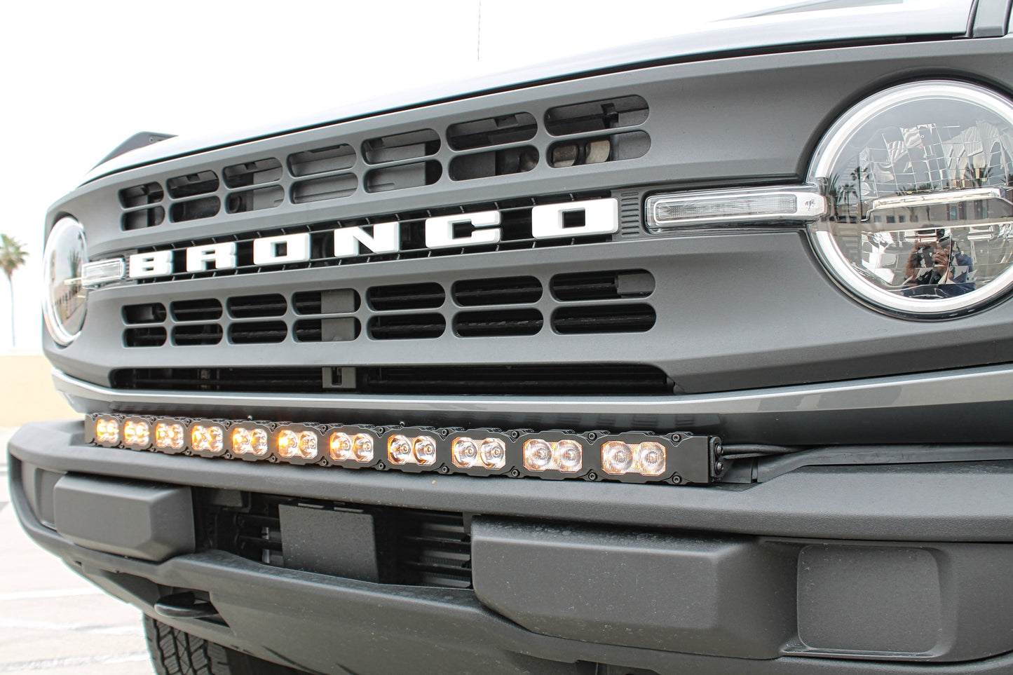 Front view of a Ford Bronco with a prominent grille and LED light bar.