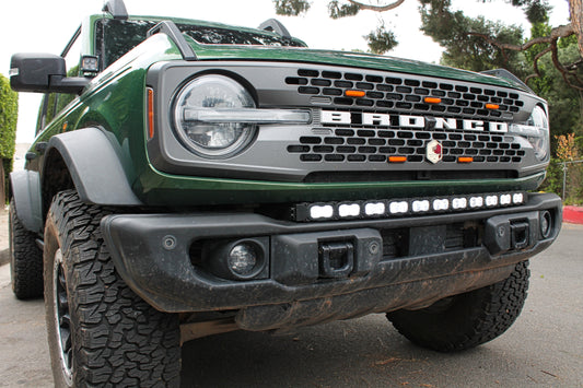 Green Ford Bronco truck with visible branding and front LED light bar