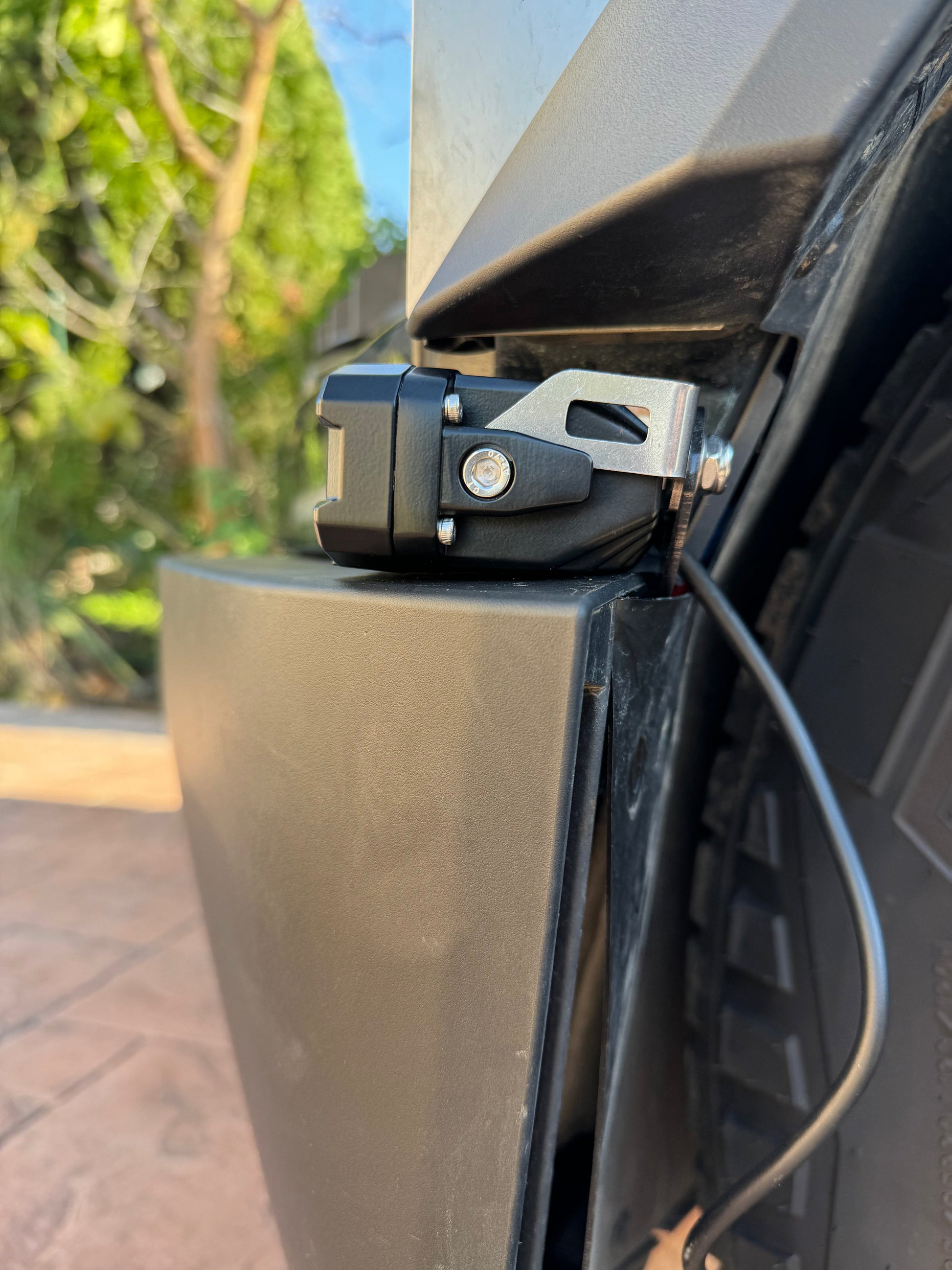 Close-up of a vehicle's hitch receiver with a blurred natural background