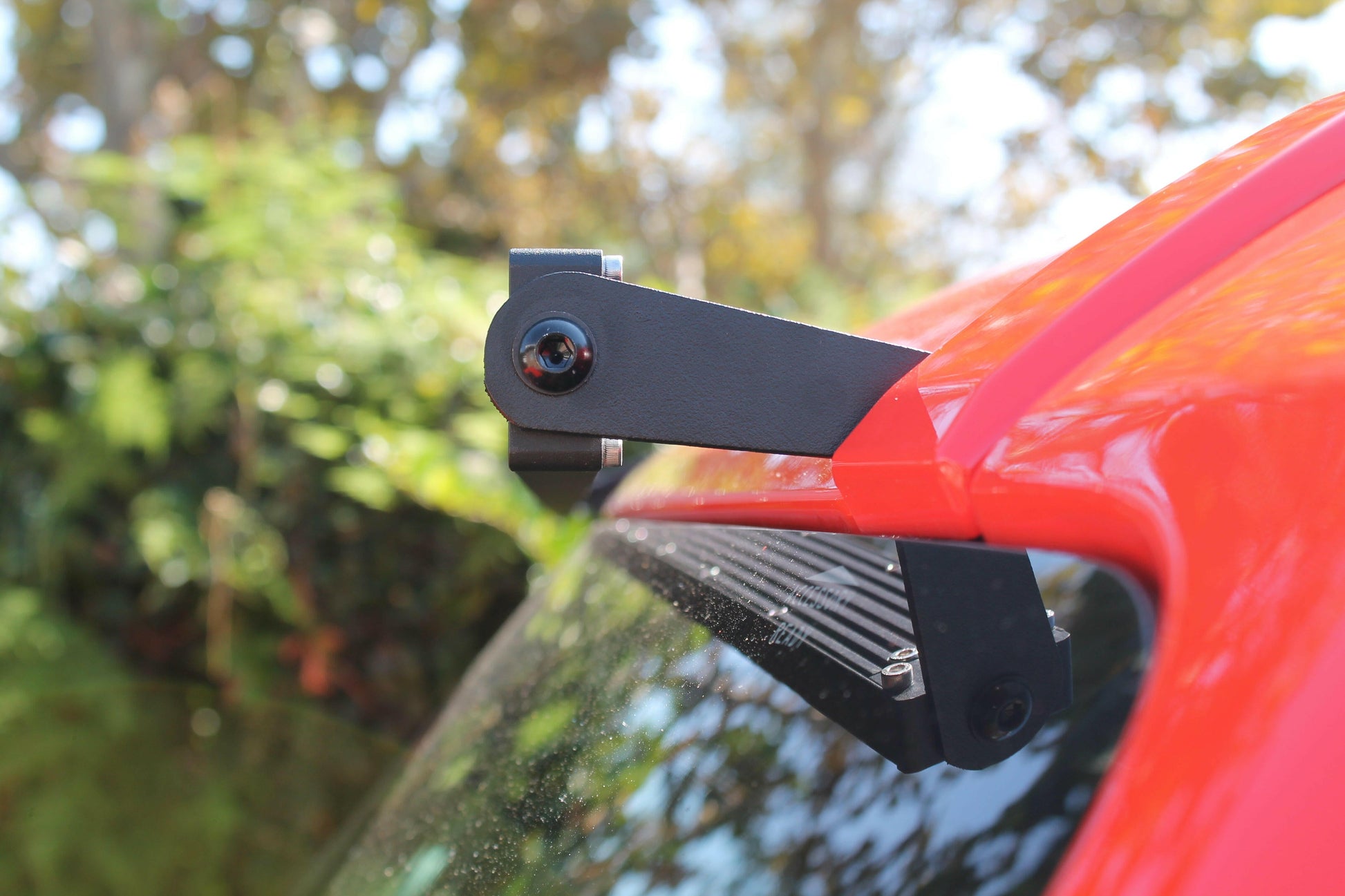 Light Bar mounted on a car's rear with a blurred natural background