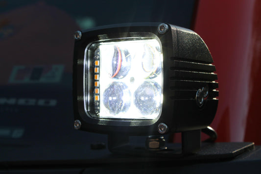 Cube-shaped LED work light on a dark background