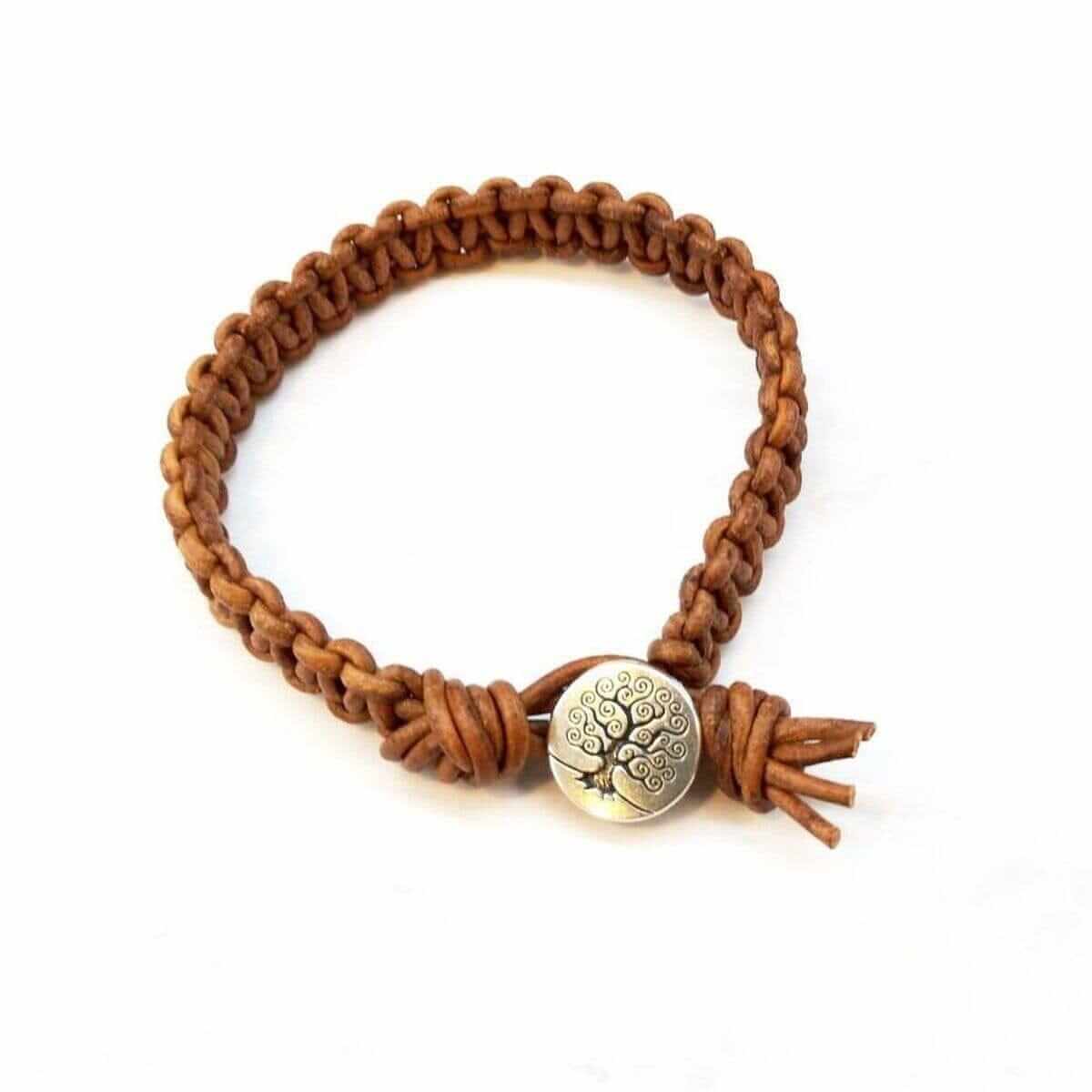 Brown braided bracelet with a decorative button clasp on a white background