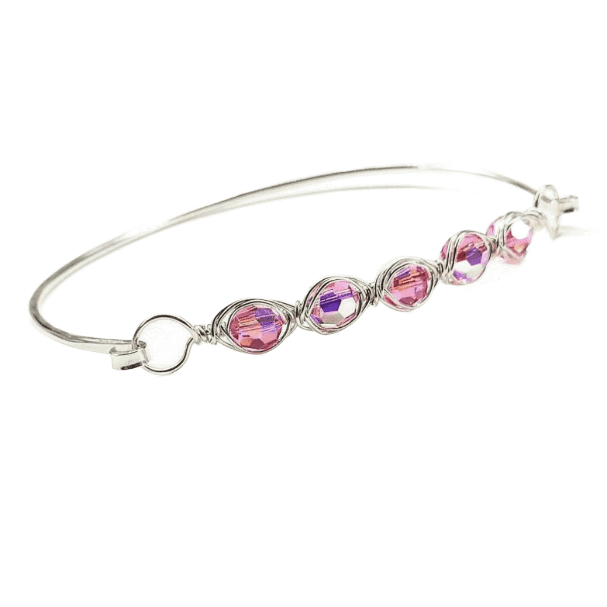 Silver bangle with pink and purple crystals on a white background