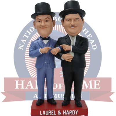 Bobbleheads of Laurel and Hardy in suits with a 'National Comedy Hall of Fame' logo in the background.