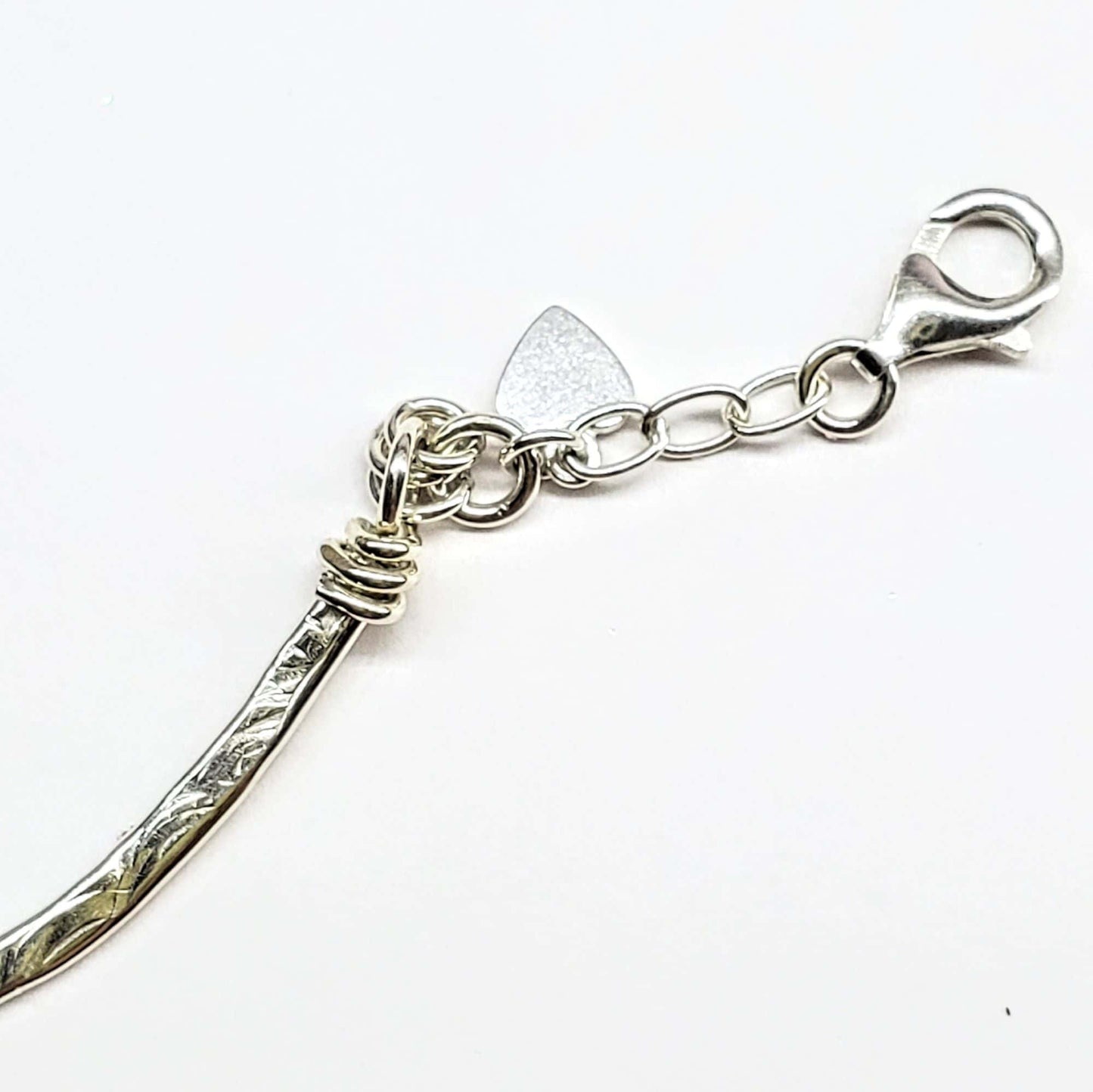 Silver clasp with a unique design on a white background