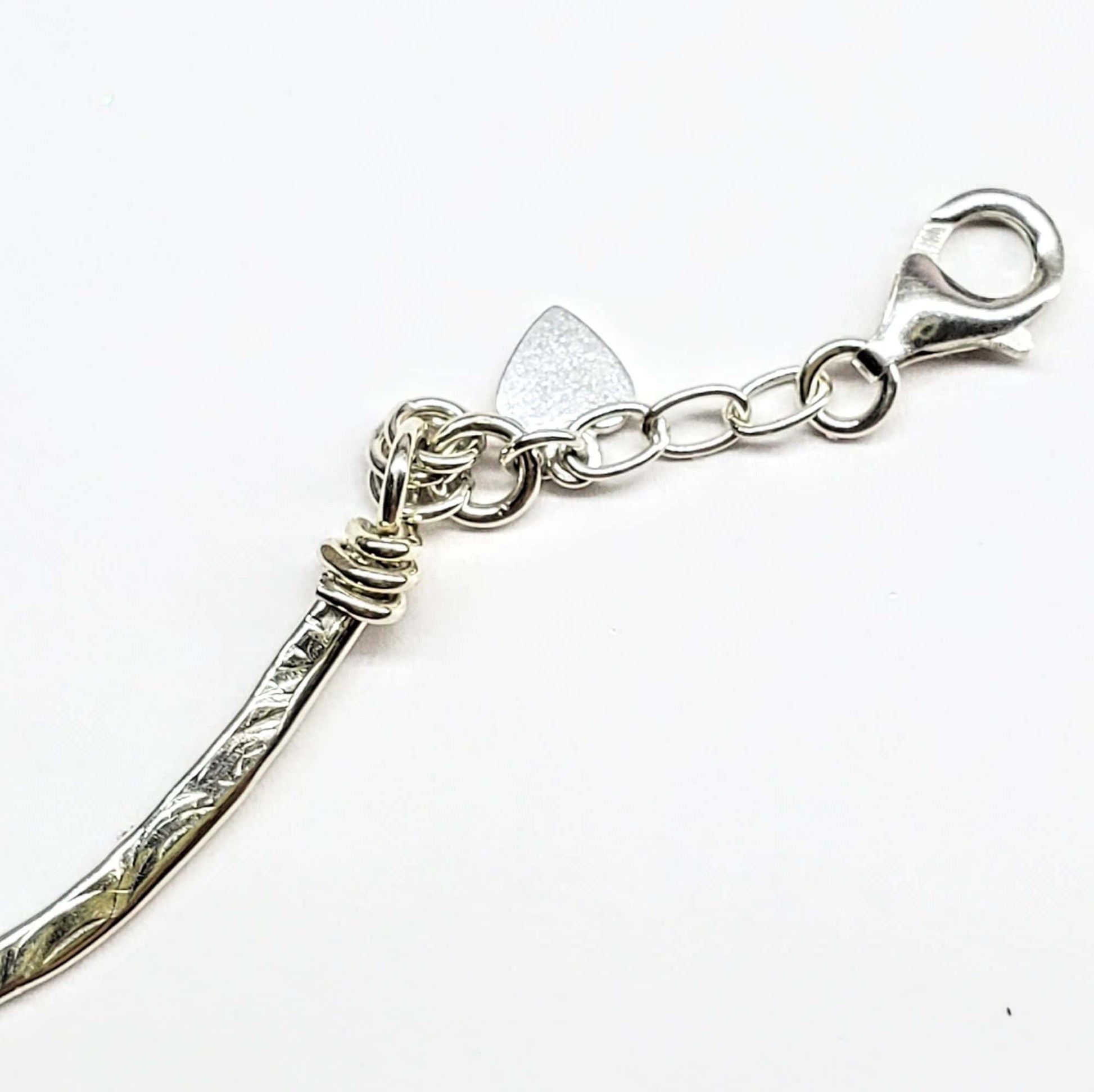 Silver clasp with a unique design on a white background
