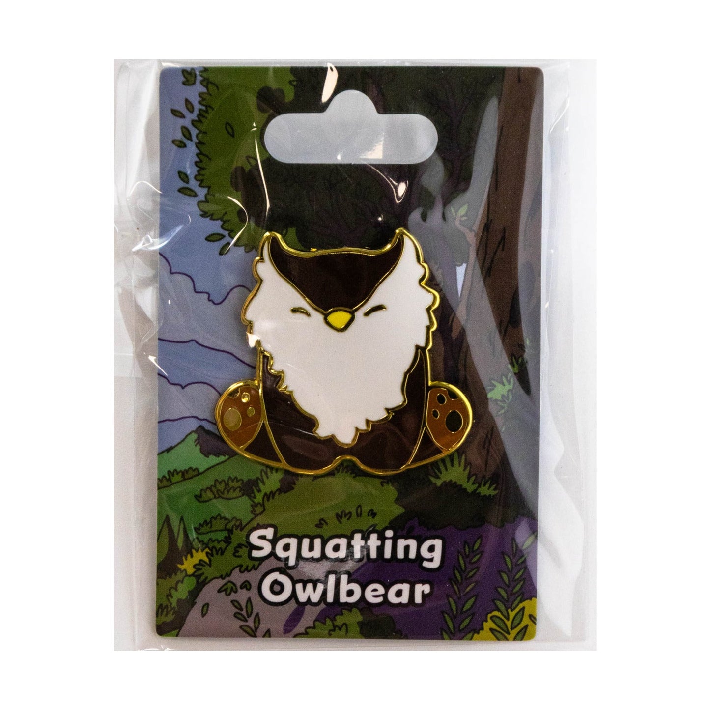 Squatting Owlbear pin in packaging with nature-themed background