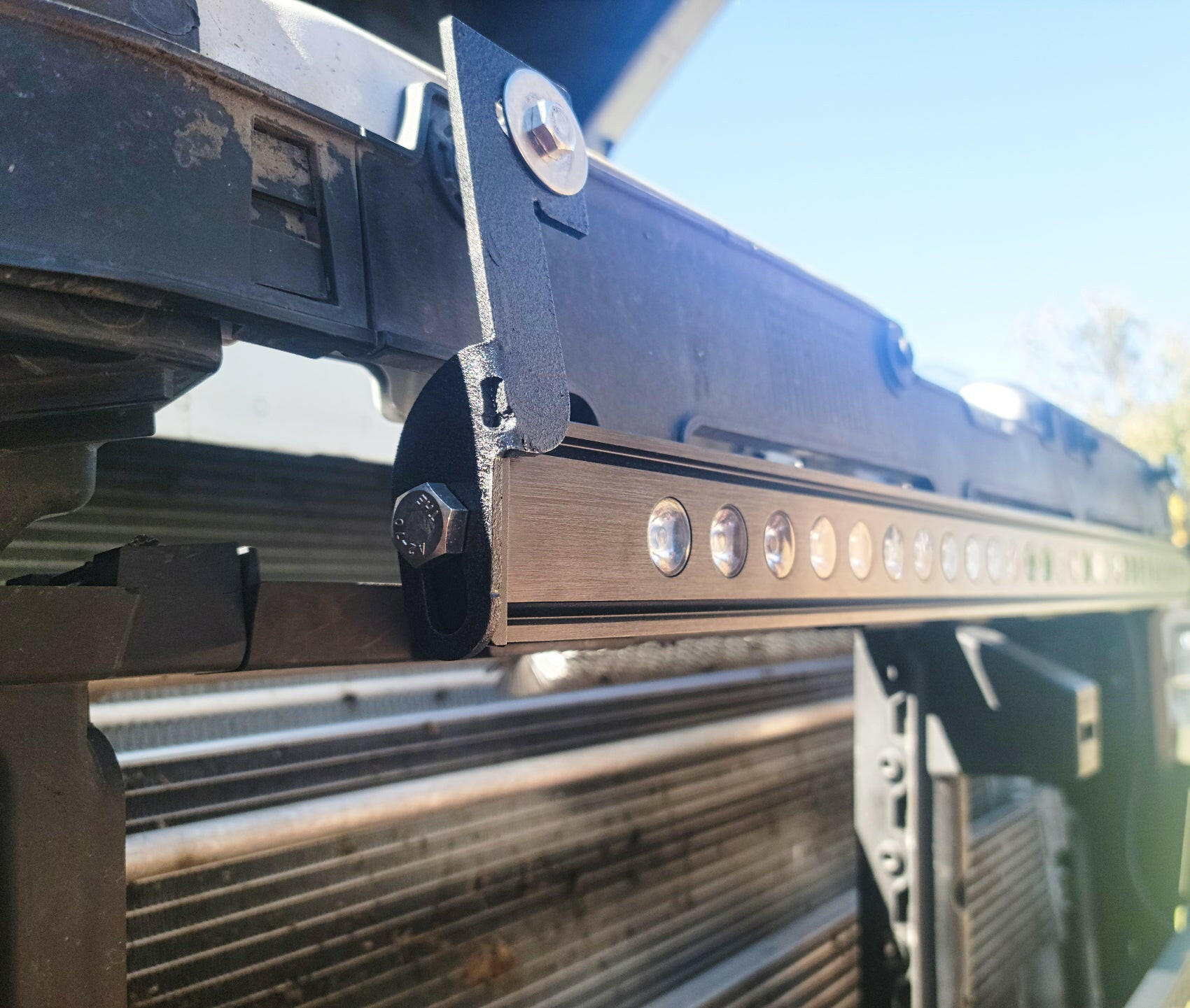 Close-up of a vehicle LED light bar system with a clear sky background
