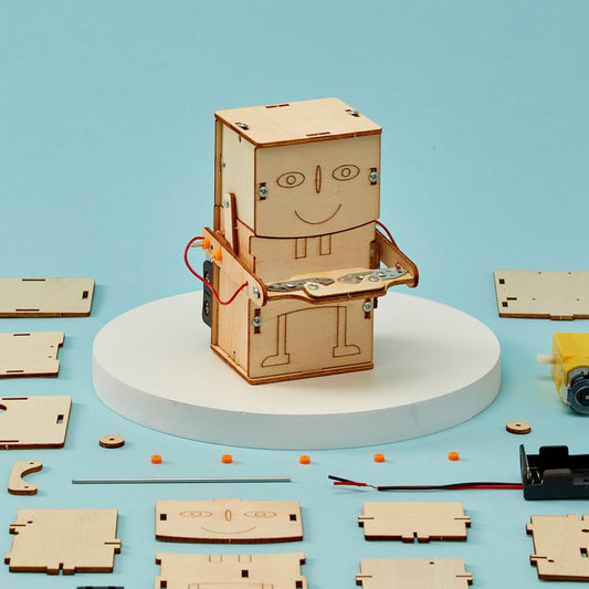 Wooden robot model kit on a blue background with scattered pieces