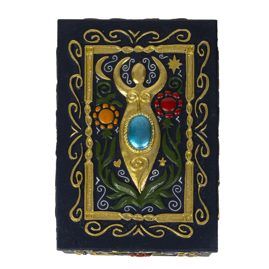 Decorative box with gold embellishments and gemstones on a black background