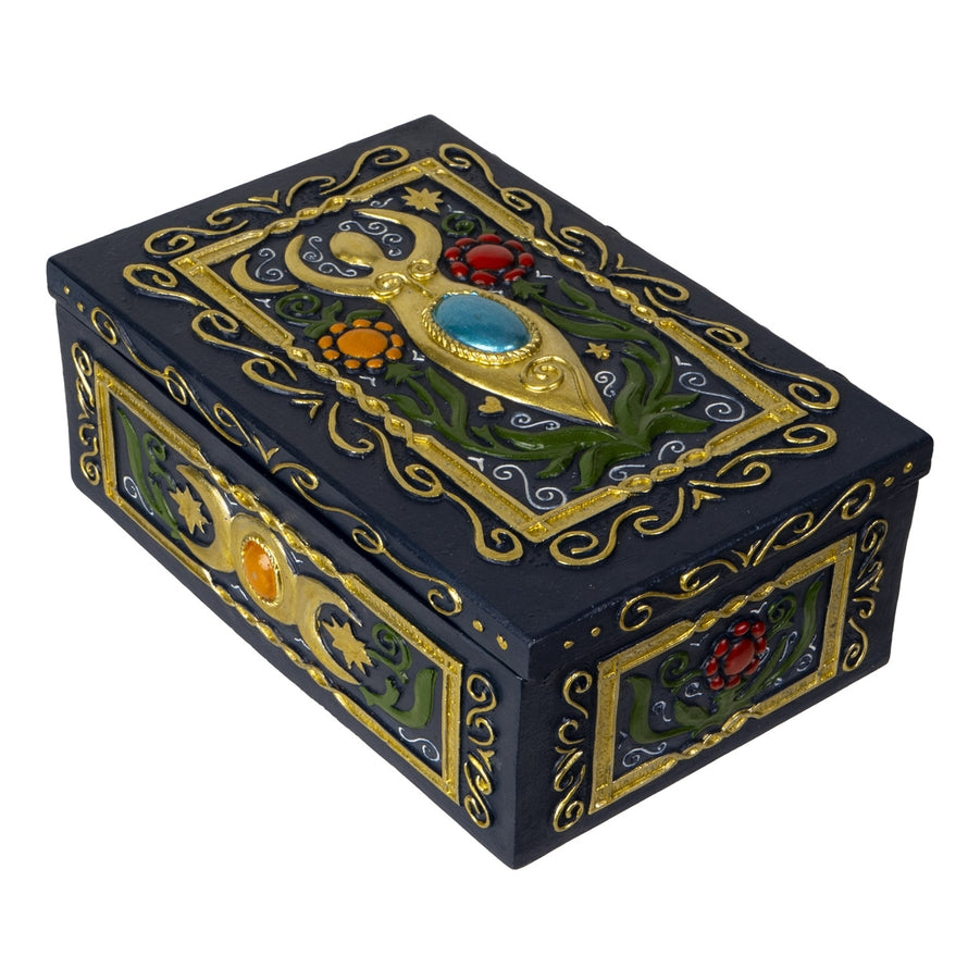 Decorative black box with gold and gemstone accents on a white background