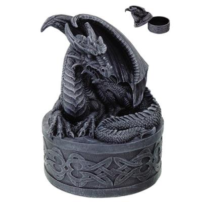 Dragon-shaped candle holder with intricate design on a white background