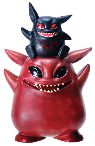 Red and black creature figurine with smaller black creature on top