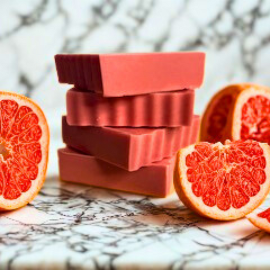Grapefruit Splash- Grapefruit Scented Handmade Soap with sliced grapefruits on a marble surface