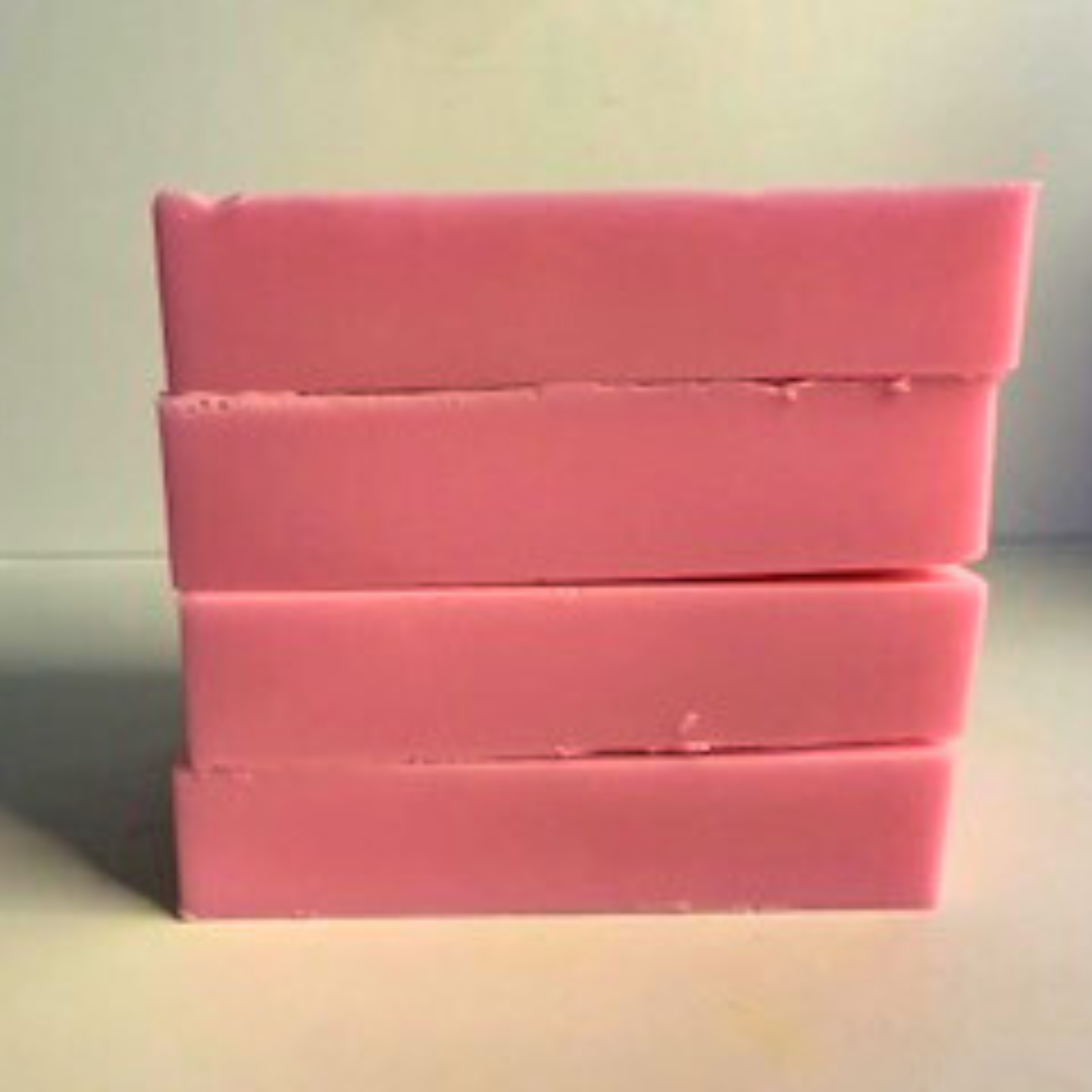 Stack of pink soap bars on a light gray background