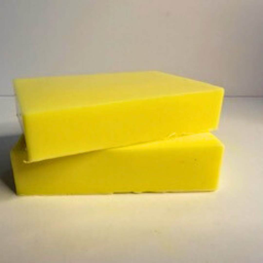 Two Lemon Zest- Lemon Scented Handmade Soap Blocks stacked on a white surface with a light gray background