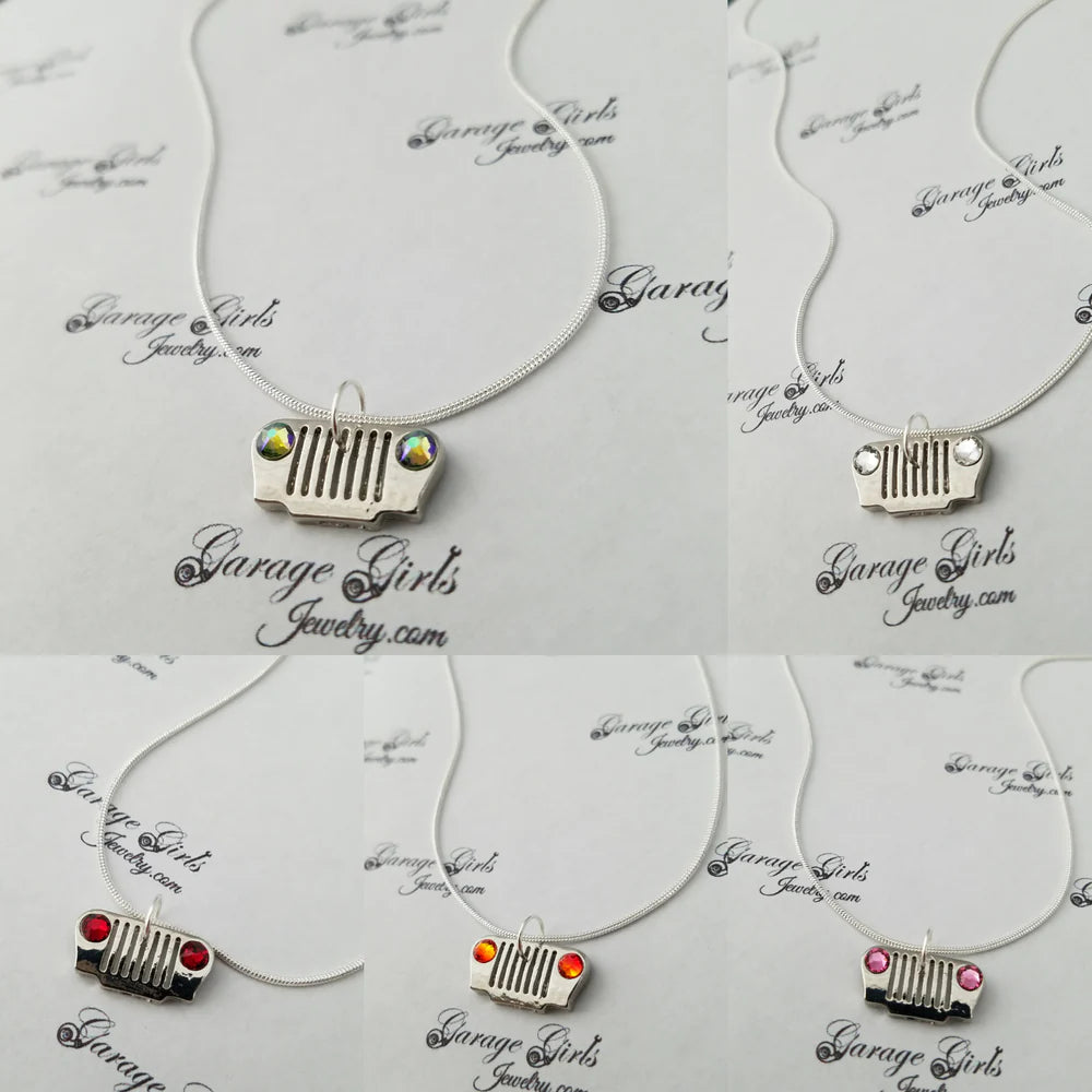 Necklaces with car grille charms on a 'Garage Girls Jewelry' branded card.