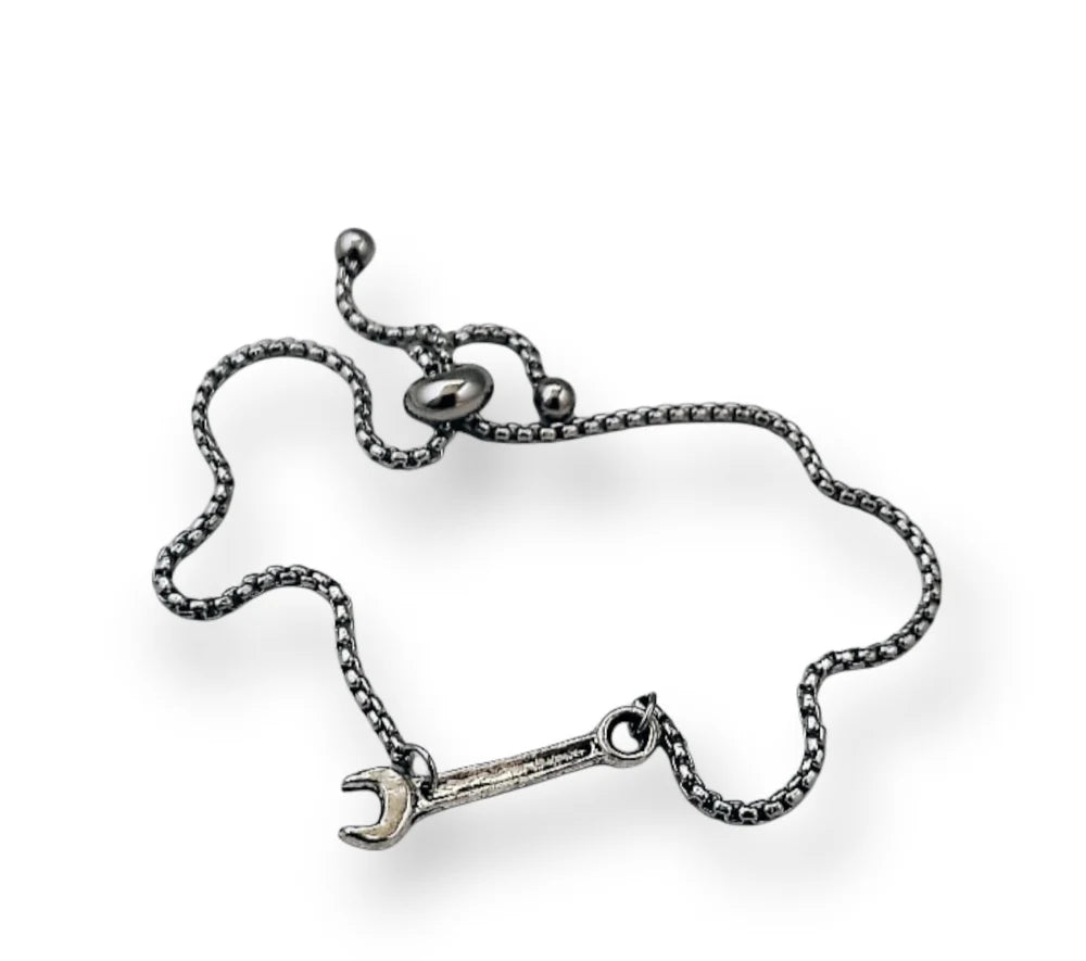 Silver bracelet with a wrench charm on a white background