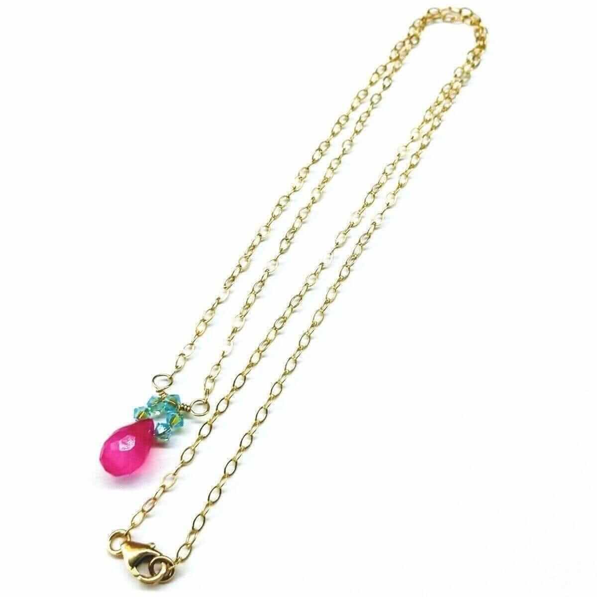 Gold chain necklace with a pink and blue pendant on a white background