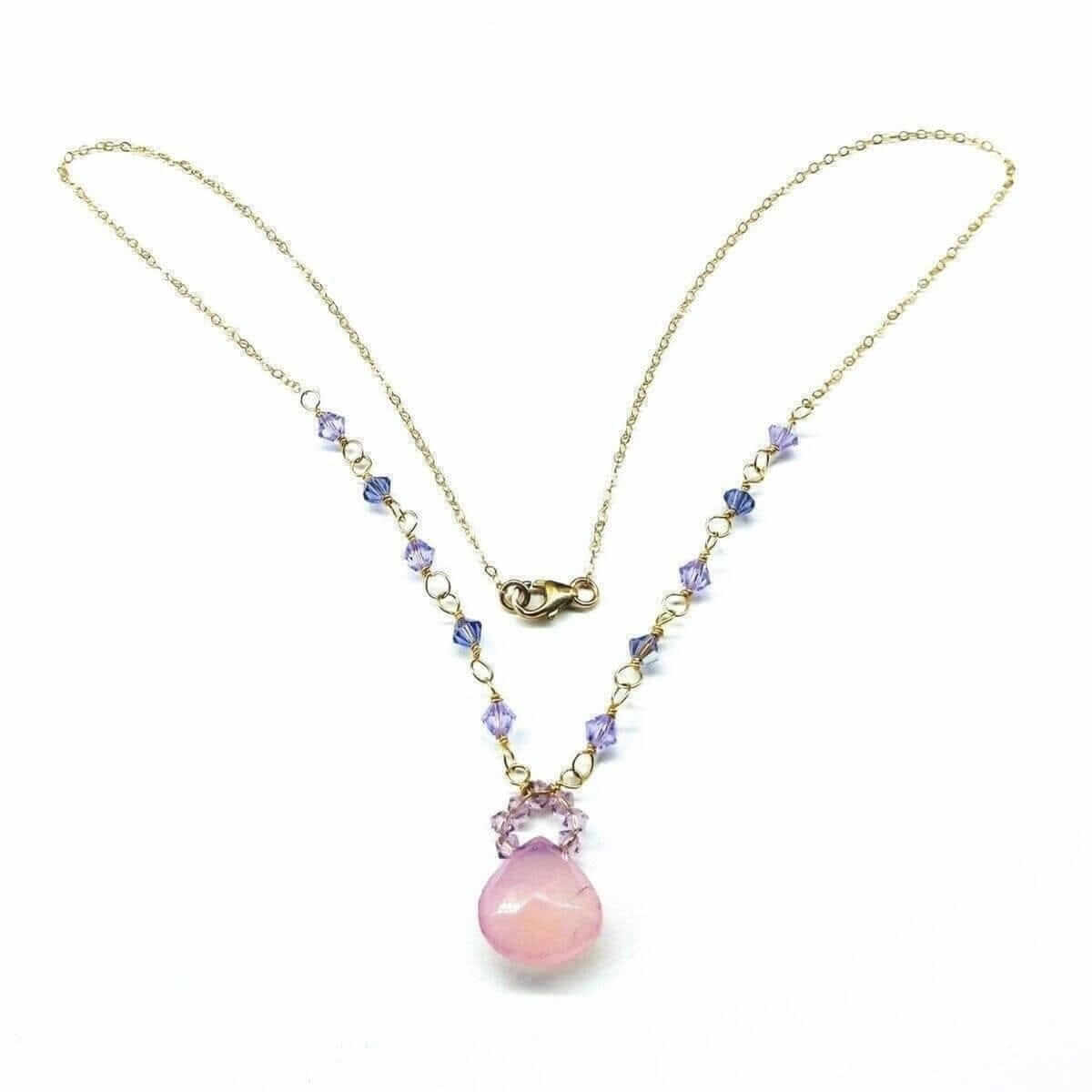 Necklace with pink pendant and purple beads on a white background