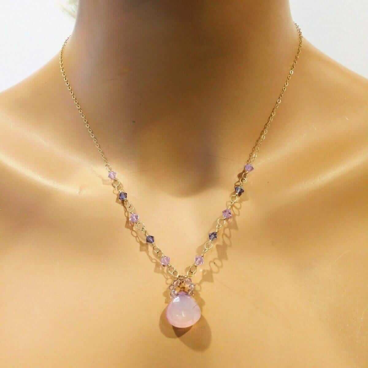 Necklace with a pink pendant on a mannequin