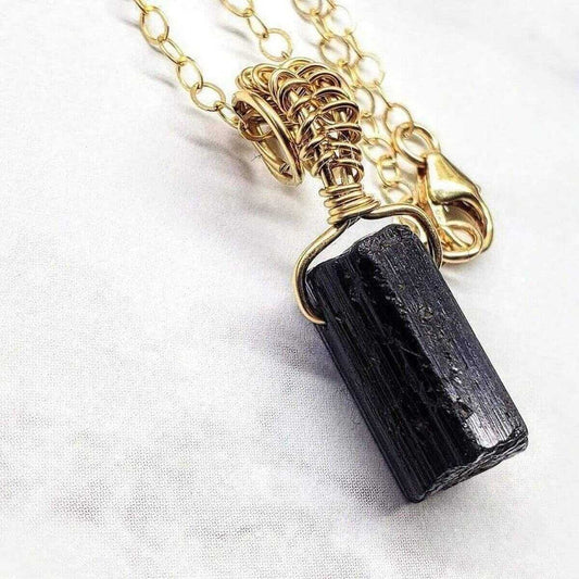 Necklace with a black stone pendant on a white background