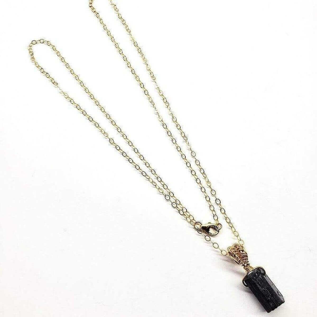 Necklace with a black pendant on a white background