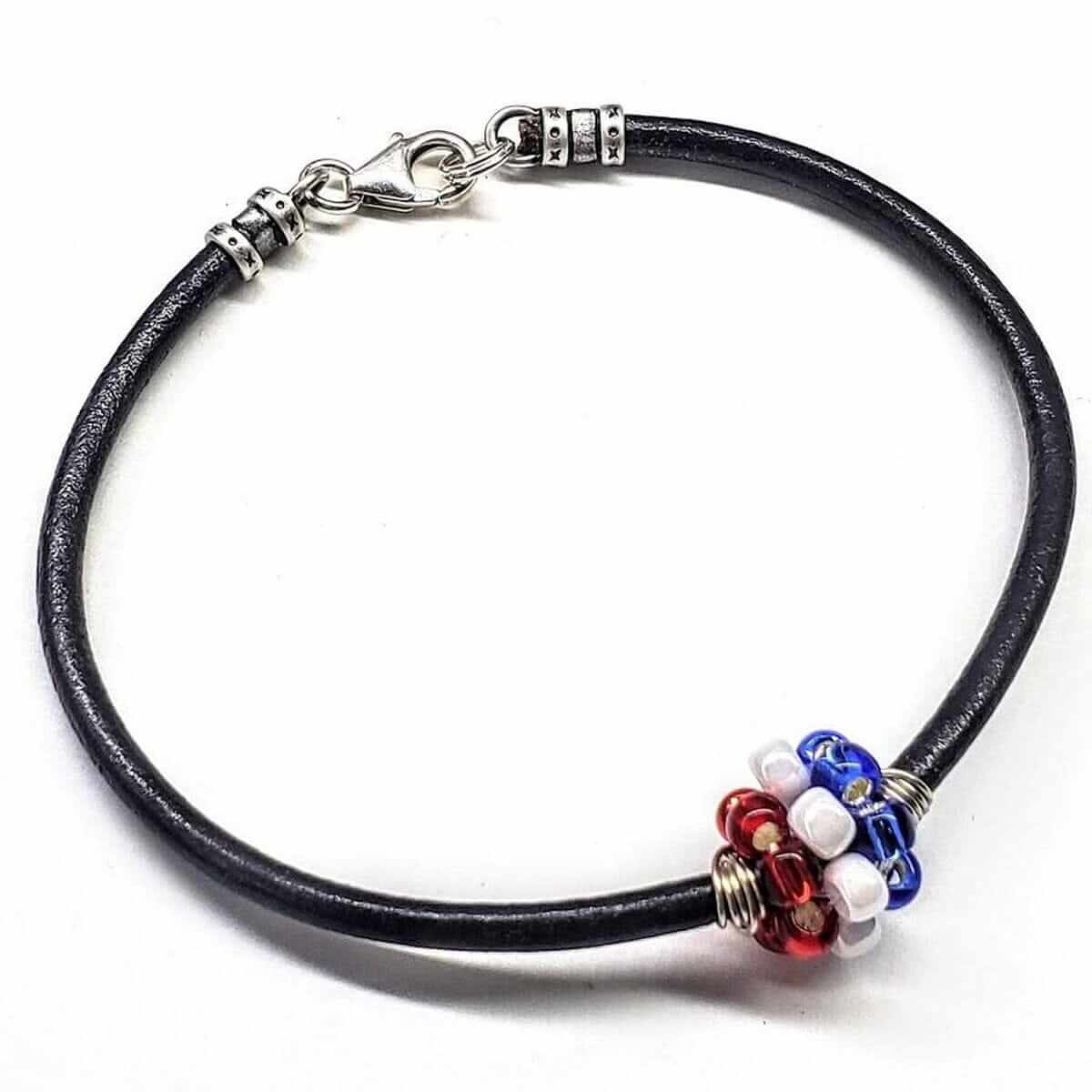 Black leather bracelet with colorful beads on a white background