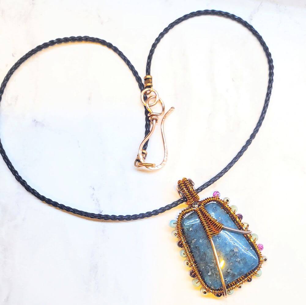Necklace with a blue pendant on a white background