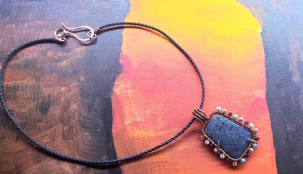 Necklace with a blue pendant on a colorful background