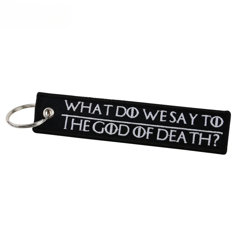 Black keychain with white text on a white background