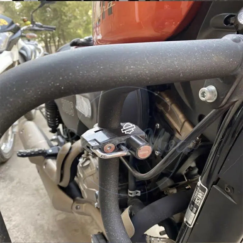 Close-up of a motorcycle handlebar with a black clamp and visible brand logo.