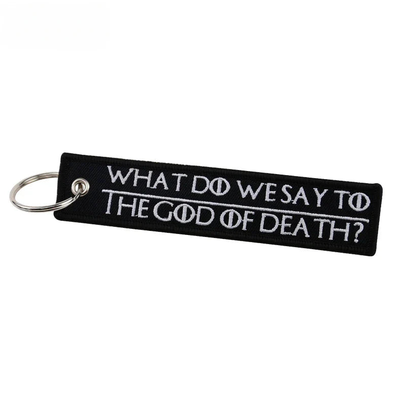 Black keychain with white text on a white background