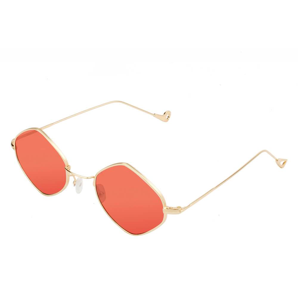 Sunglasses with gold frame and red lenses on a white background